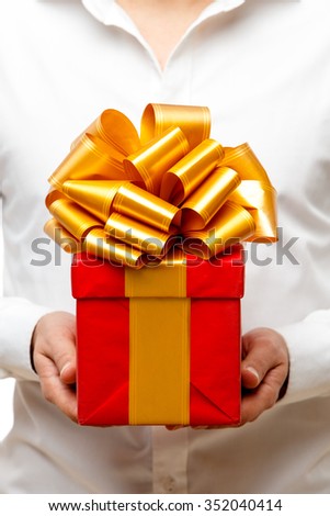 Young man carries a lot of presents, isolated on white