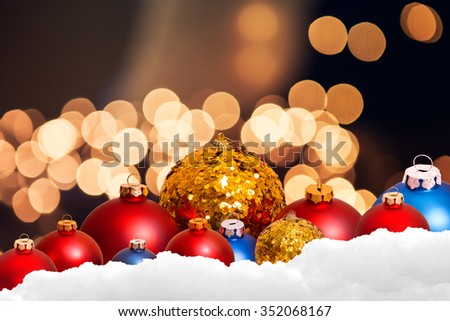 christmas ornament in snow on bokeh background