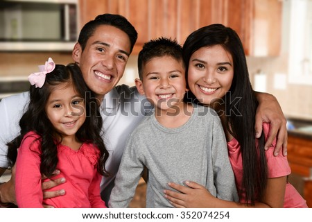 Happy young couple who are standing with their son