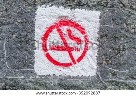 No smoking symbol sprayed on an ancient concrete wall.