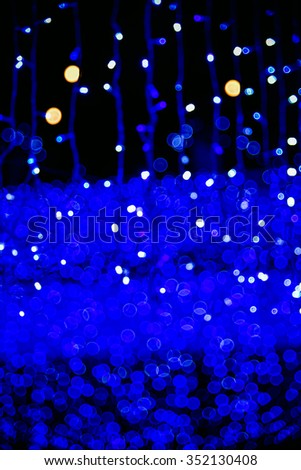 Colorful Glowing Christmas stars Lights on dark background. 