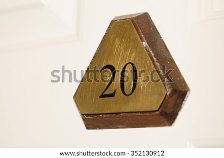 Metal number 20 triangular hotel room door sign