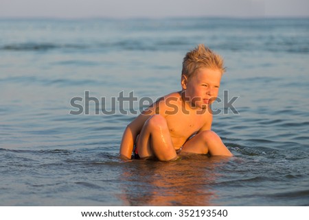 Boy 5 years playing in the sea. A boy swims in the sea.