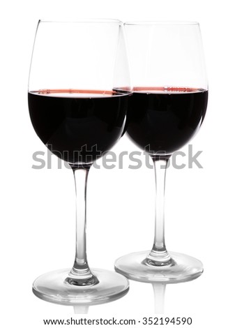 Two glasses of red wine on light background