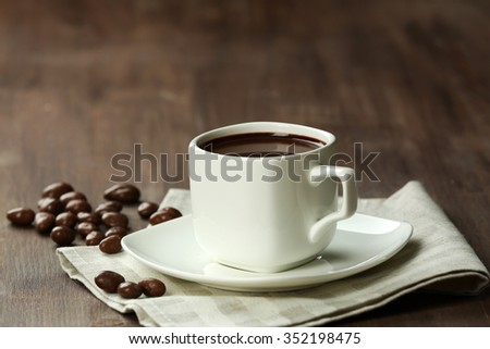 Cacao with sweets on wooden background