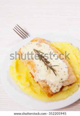 fish fillet under cheese with mashed potatoes