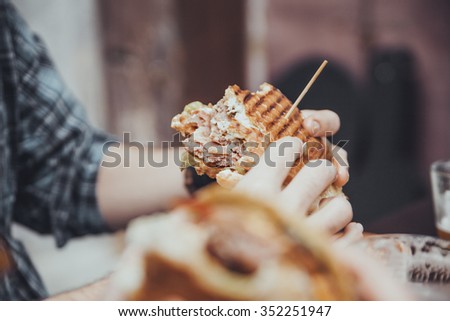 Close Up Of Mans Hands Holding Delicious Burger