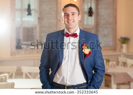 groom in a red bow tie wedding ceremony
