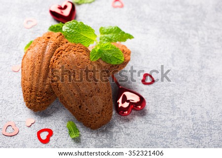 Homemade chocolate cookies Madeleine with mint and Valentine's day decorations. Holidays food background with copy space for text.