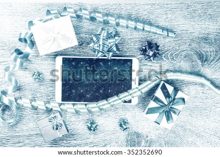 Christmas gifts on wooden background. Holiday image for New Year and Christmas. Vintage texture for design uses.