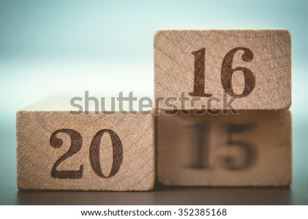 Abstract year 2016 number on wood block is coming concept. Happy New Year 2016 replace blur 2015 concept