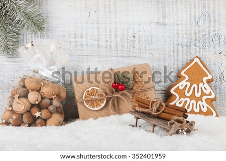 Christmas and New Year background with gift box, Christmas cookie gingerbread and Christmas decorations on the snow
