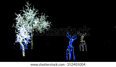  Christmas scene with illuminated tree and  deer outdoor