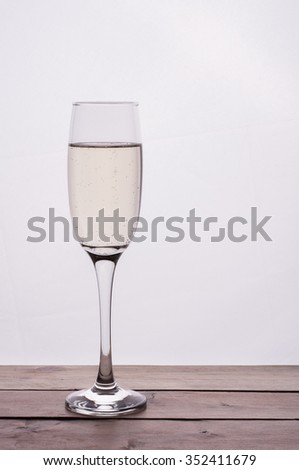 photo of Champagne glass on wooden table against white background
