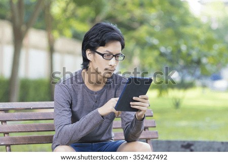 Man Use Tablet at Park