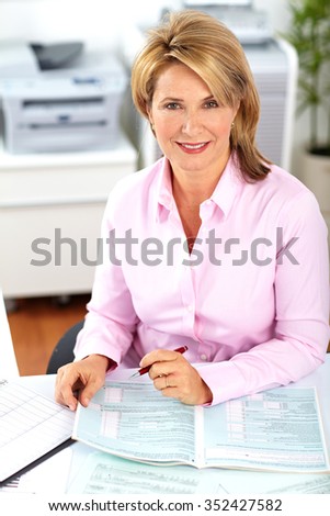 Beautiful mature business woman working in modern office.