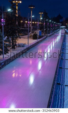 Blank big rink at night. Skating Rink in pink lights.