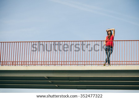 Young long haired girl protect eyes from on the urban bridge. Lifestyle funky in summer. Trendy sport teen.