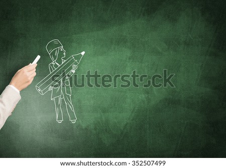 Female hand drawing with chalk doctor on blackboard