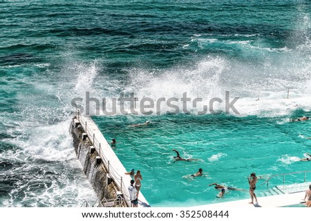Beach Scene: Rock Swimming Pools overlooking Tasman Sea in Bondi, Sydney - Australia. Royalty-Free Stock Photo #352508444