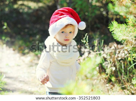 Christmas and people concept - portrait baby in santa red hat