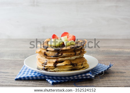 Pancakes with chocolate, strawberries and kiwi