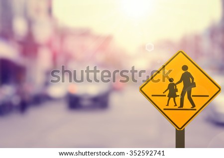 School sign on blur traffic road background.Retro color style.