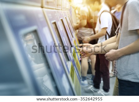 young man paying at ticket machine in a metro station Royalty-Free Stock Photo #352642955