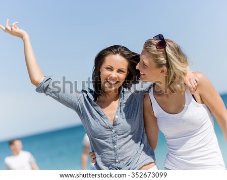 A picture of two women having good time on beach