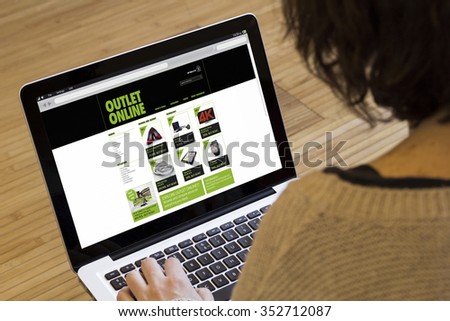 shopping online concept: outlet online on a laptop screen. Screen graphics are made up.