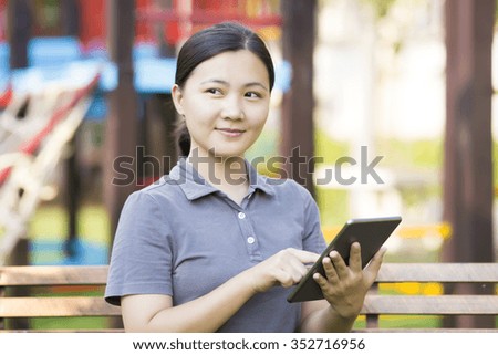 Woman Use Tablet at Park