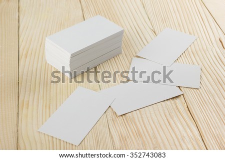 White blank business visit card, gift, ticket, pass, present close up on wooden background. Copy space Blank corporate identity package business card Template for ID