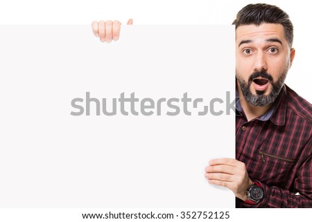 Man holding a placard and surprised.