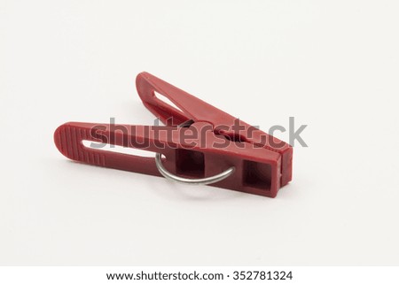 single red clothespin on a white background
