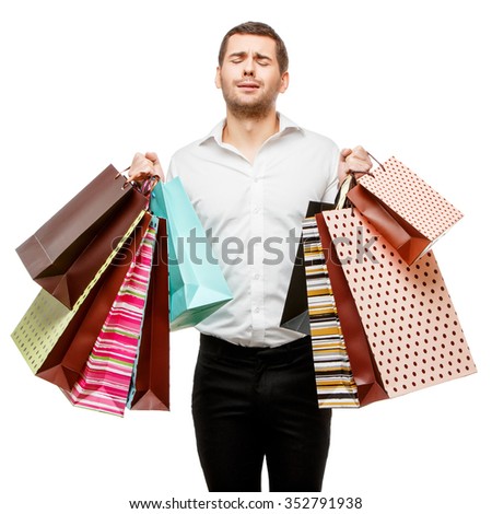 Full isolated studio picture from a young man with shopping bags
