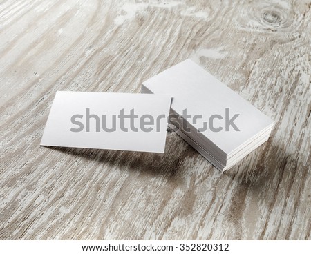 Blank business cards on wooden background. Mockup for branding identity for designers.