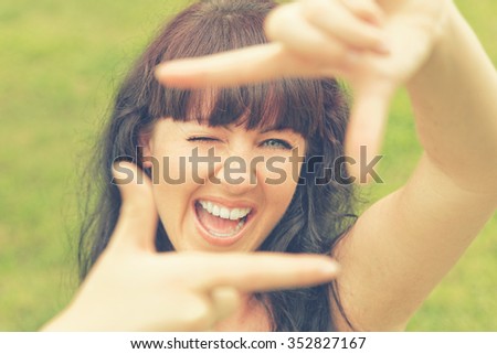 Woman framing with imaginable camera