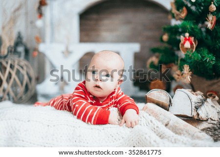 funny little boy on the background of the Christmas tree. Christmas decorations