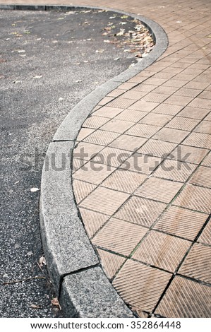 Part of a curved pavement next to a road