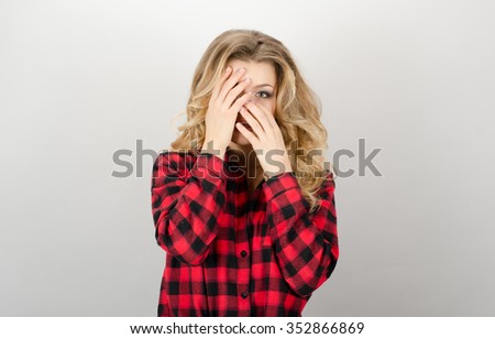A picture of a scared woman covering her eyes