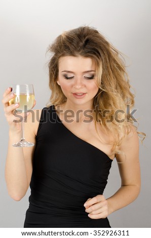 Beautiful blond woman drinking white wine