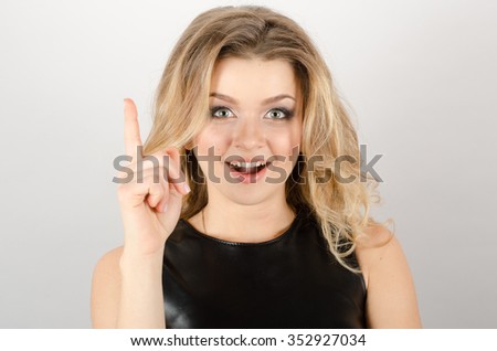Young surprised happy woman pointing up having an idea