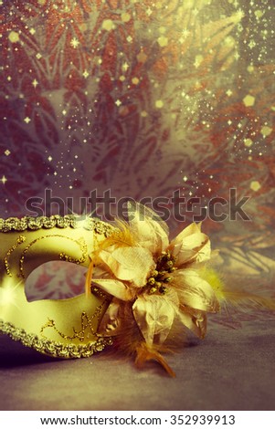 Vintage gold carnival mask on a gold background.