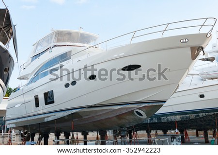 Luxury yacht at shipyard waiting for maintenance in Phuket, Thailand Royalty-Free Stock Photo #352942223