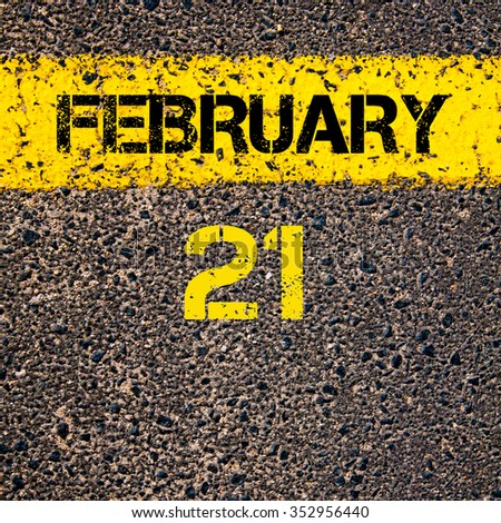 21 February calendar day written over road marking yellow paint line