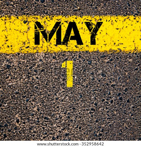 1 May calendar day written over road marking yellow paint line