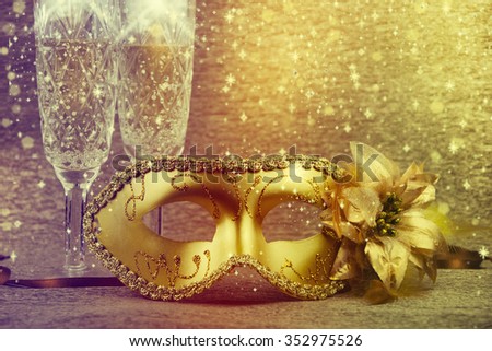 Vintage gold carnival mask on a gold background.