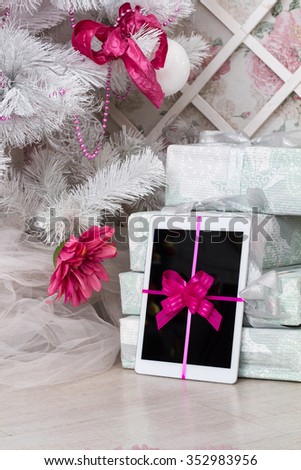 White tablet as a gift under the Christmas tree