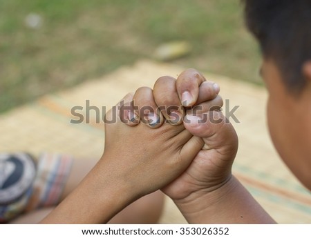 Asian boy Join his dirty hand with his friend. 