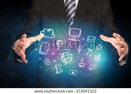 Businessman holding hand drawn media icons